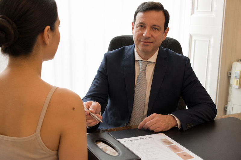 Mole removal consultation discussing benign skin lesion assessment